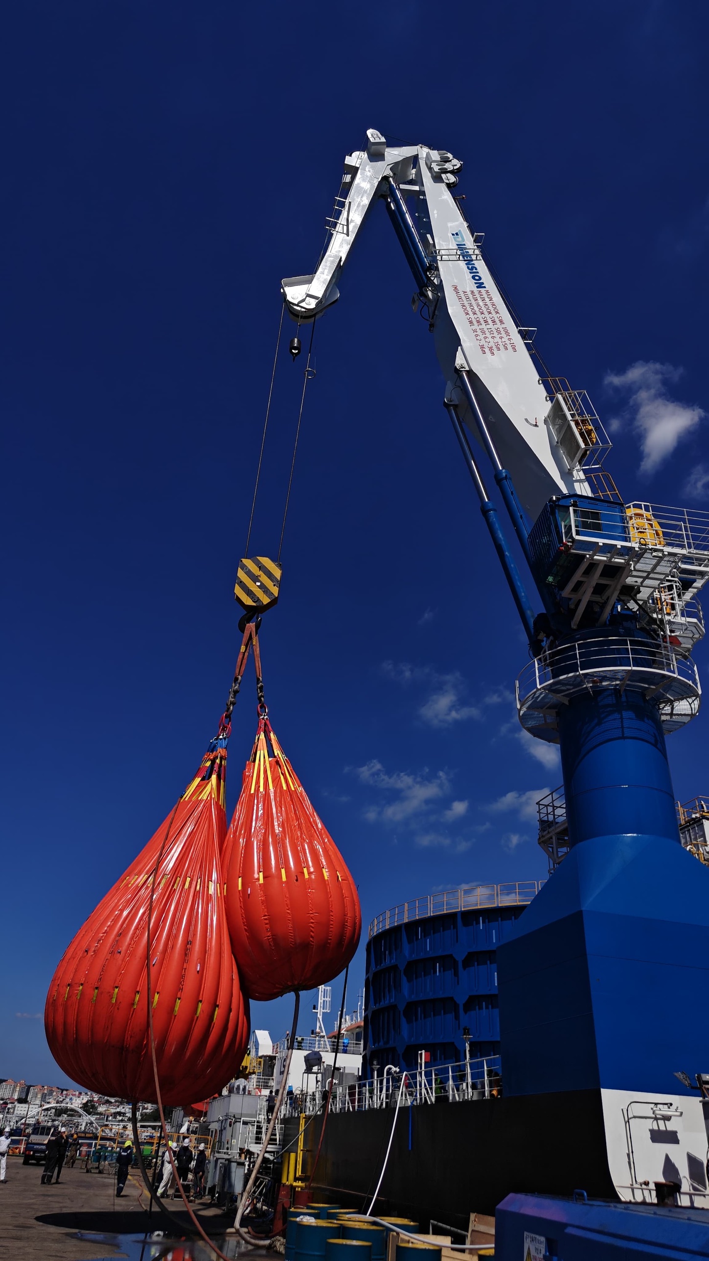 100 MT knuckle boom crane lifting water-bag test weights during load testing